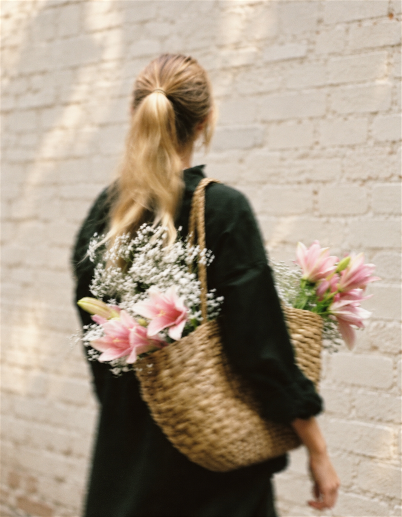 Flowers carried in a woven basket at a floral market